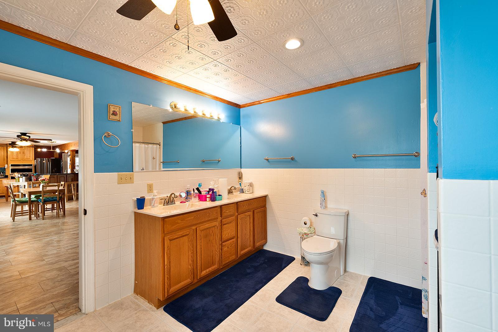 2613 Hoopers Island Road Fishing Creek, MD 21634 - Photo 24 of 54 a bathroom with a sink a toilet and a mirror