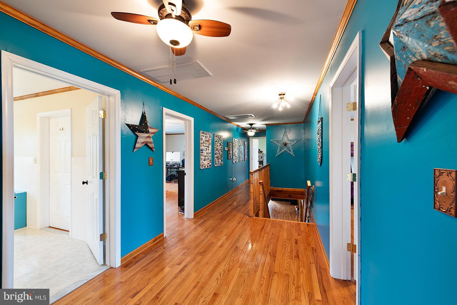 2613 Hoopers Island Road Fishing Creek, MD 21634 - Photo 26 of 54 a bedroom with a bed and a chandelier