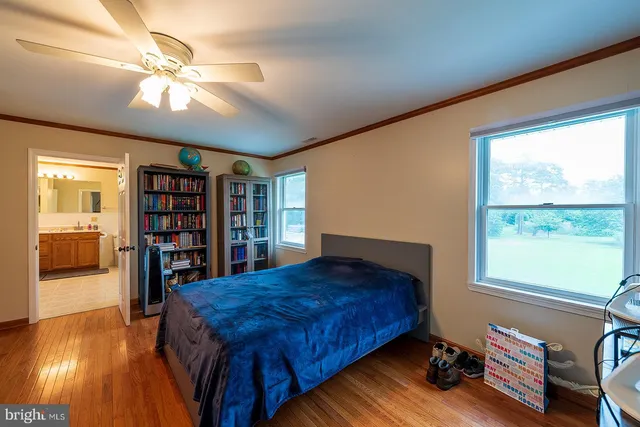 a bedroom with bed and a chandelier