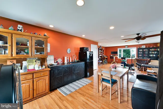 a bed sitting in a spacious bedroom next to a window