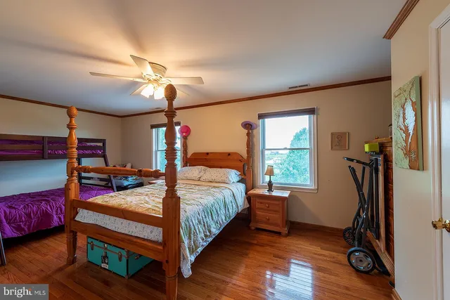 a bedroom with furniture and wooden floor