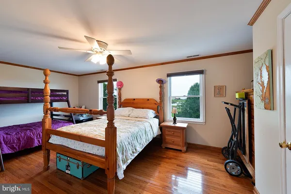 a bedroom with furniture and wooden floors