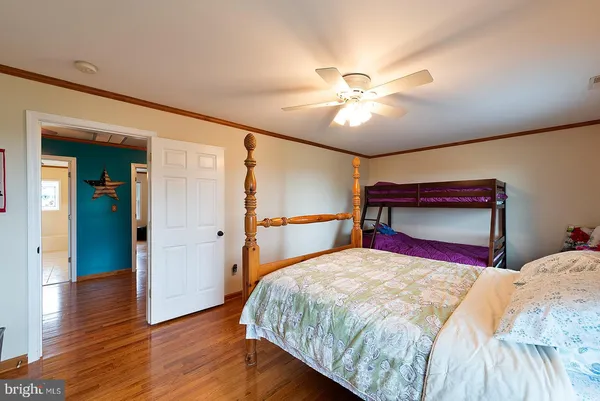 a bedroom with furniture and a flat screen tv