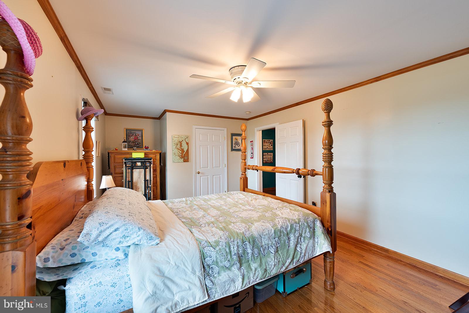 2613 Hoopers Island Road Fishing Creek, MD 21634 - Photo 37 of 54 a bed sitting in a spacious bedroom next to a window