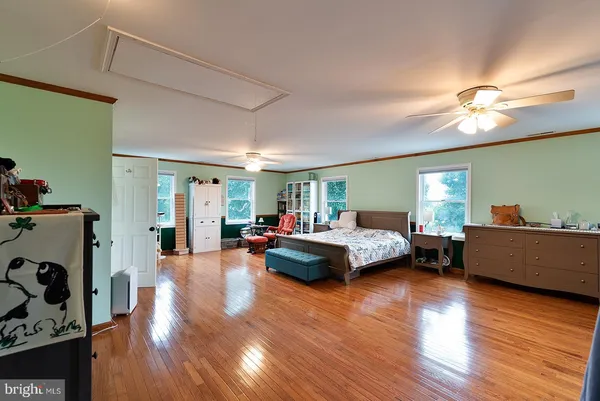 a kitchen that has a lot of cabinets and wooden floor
