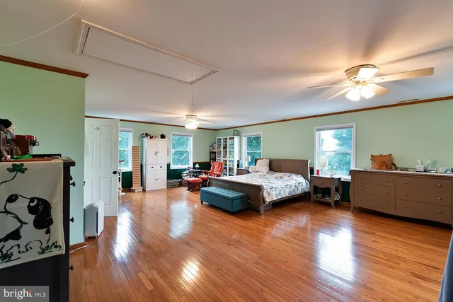a kitchen that has a lot of cabinets and wooden floor