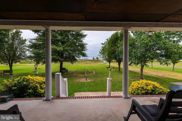 a view of a porch with furniture and garden