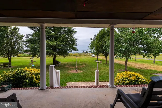a view of a porch with furniture and garden