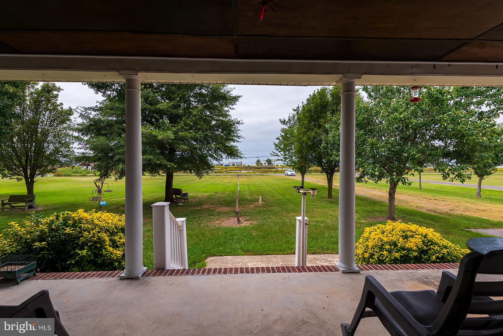 2613 Hoopers Island Road Fishing Creek, MD 21634 - Photo 4 of 54 a view of a porch with furniture and garden