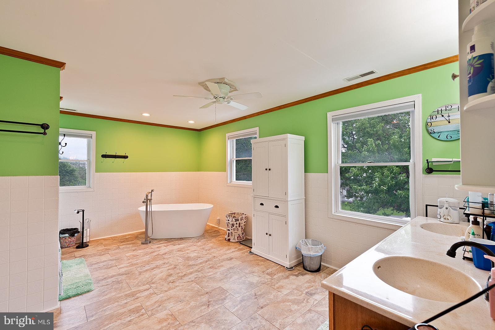 2613 Hoopers Island Road Fishing Creek, MD 21634 - Photo 41 of 54 a bathroom with a sink a bathtub and a window