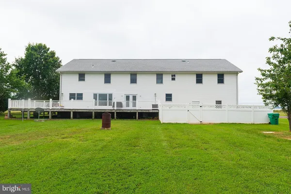 a aerial view of a house with a yard and deck
