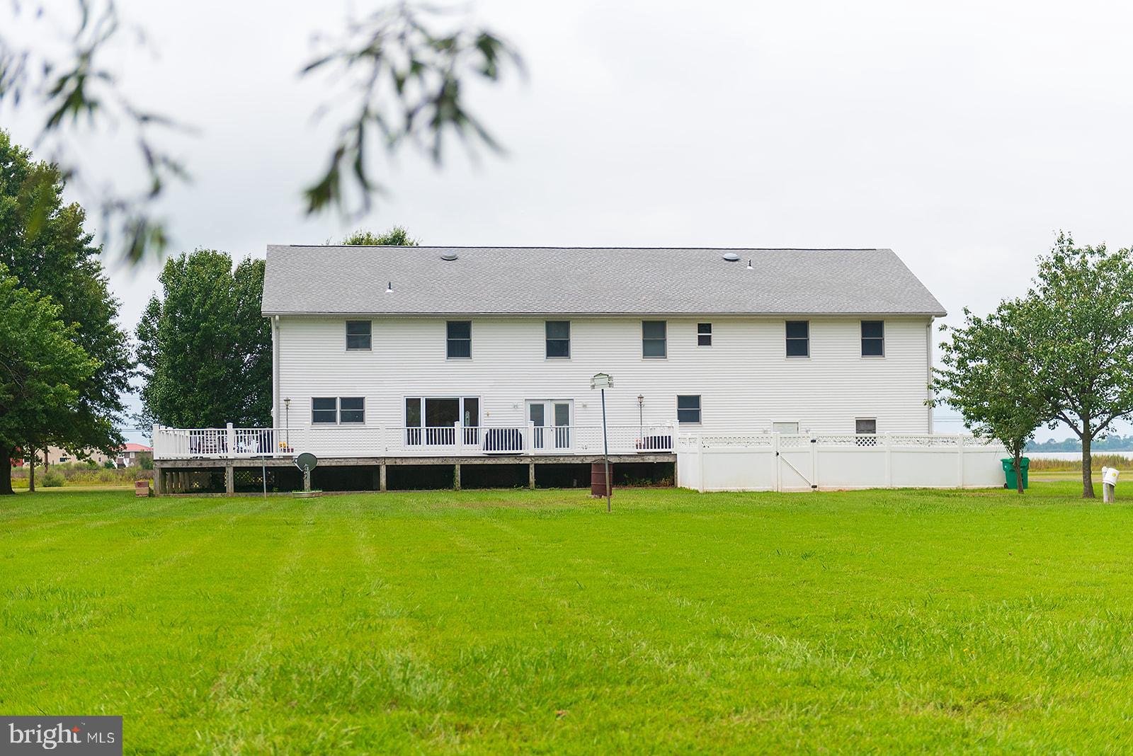 2613 Hoopers Island Road Fishing Creek, MD 21634 - Photo 46 of 54 a front view of a house with a garden and yard
