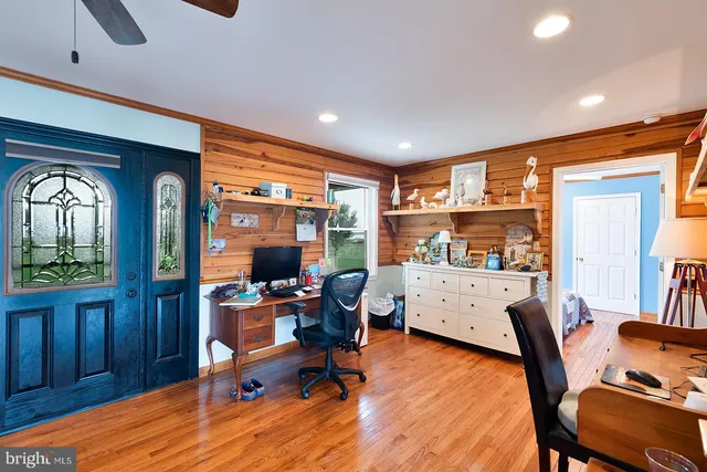a view of a livingroom with workspace and a window