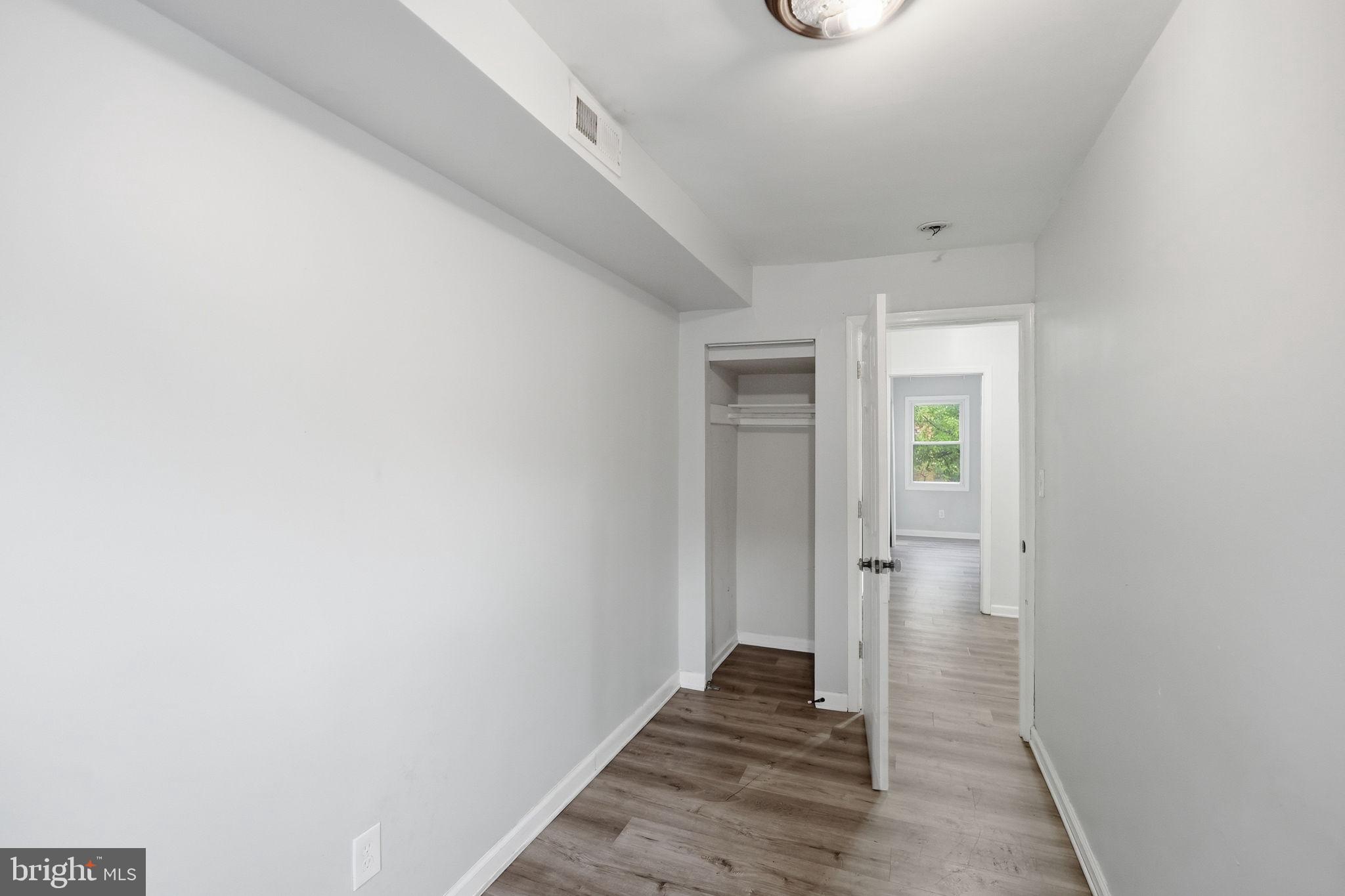 3417 B Street Southeast Washington, DC 20019 - Photo 11 of 22 a view of a hallway with wooden floor and a bathroom