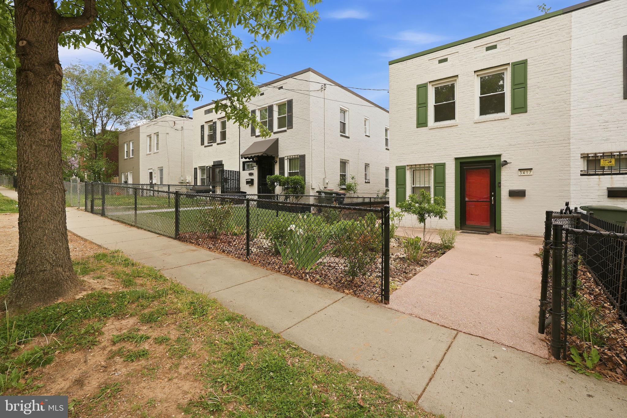 3417 B Street Southeast Washington, DC 20019 - Photo 4 of 22 a view of a white house with a yard
