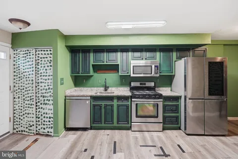 a kitchen with cabinets and stainless steel appliances