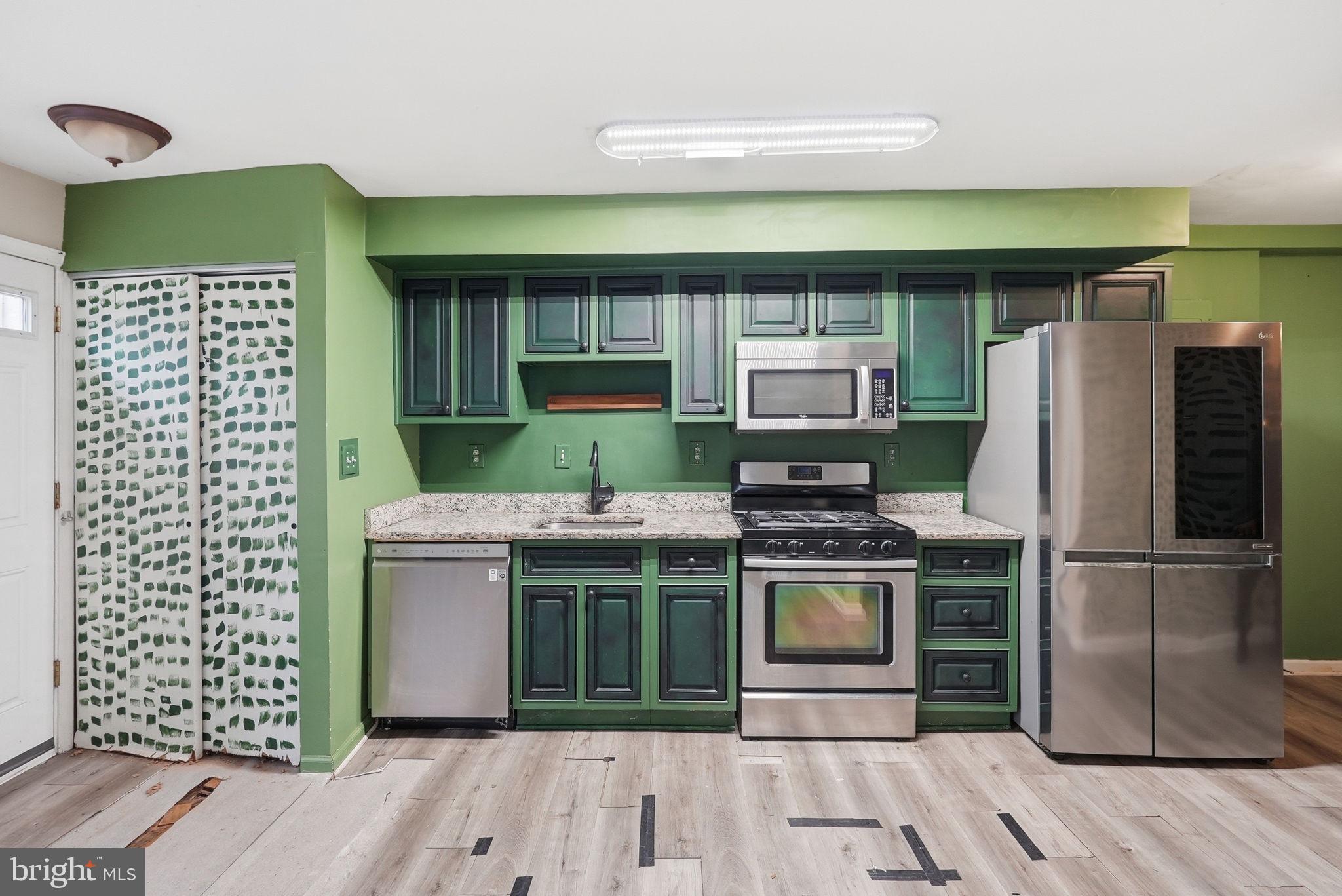 3417 B Street Southeast Washington, DC 20019 - Photo 8 of 22 a kitchen with cabinets and stainless steel appliances