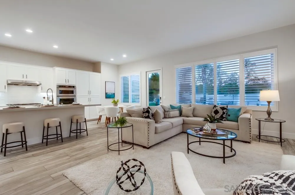 6814 Moorhen Place Carlsbad, CA 92011 - Photo 11 of 37 a living room with furniture kitchen view and a large window