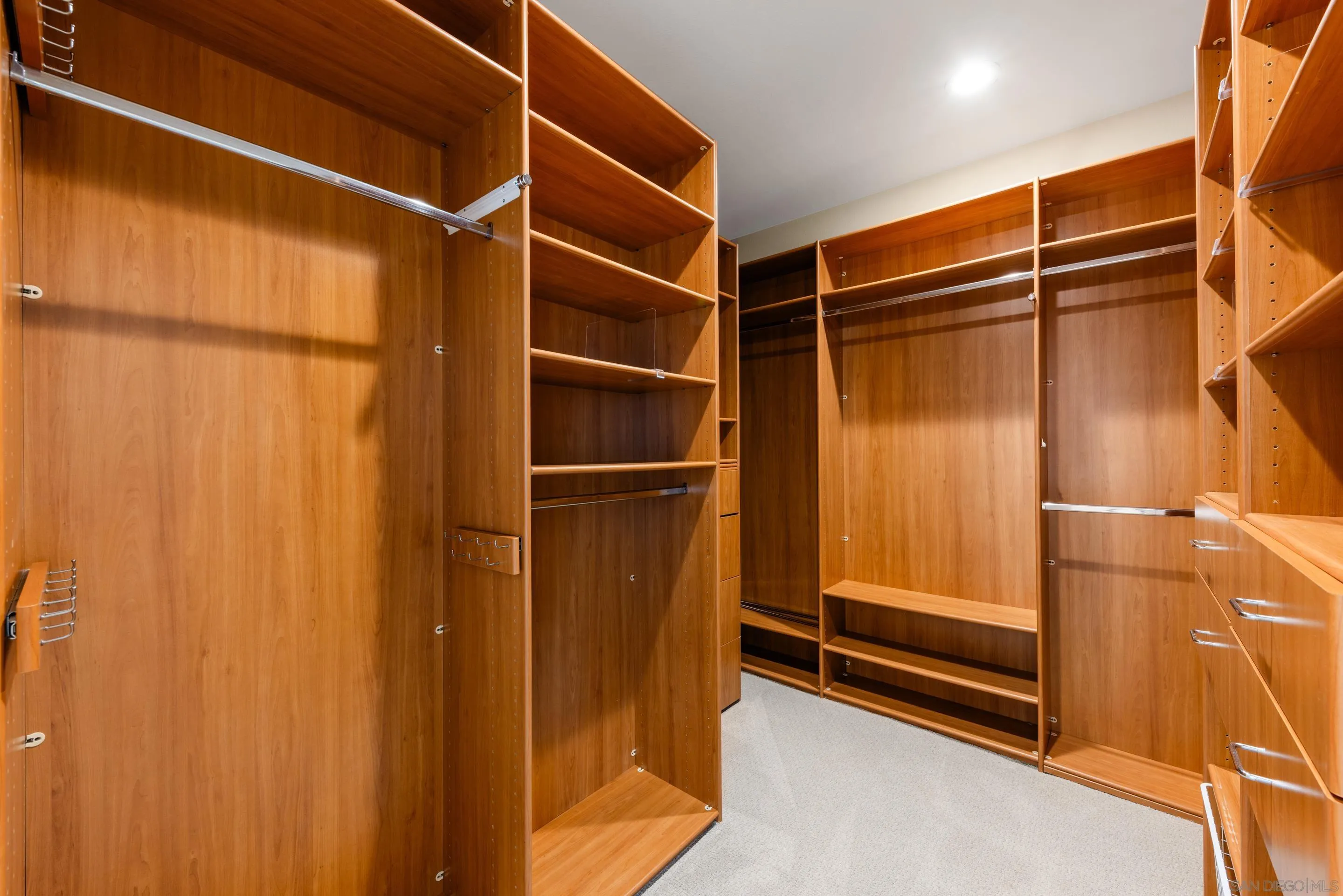 6814 Moorhen Place Carlsbad, CA 92011 - Photo 17 of 37 a view of walk in closet with empty racks