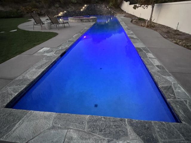 a view of a swimming pool with a yard