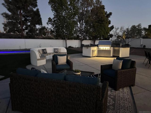 a living room with furniture a lamp and a potted plant