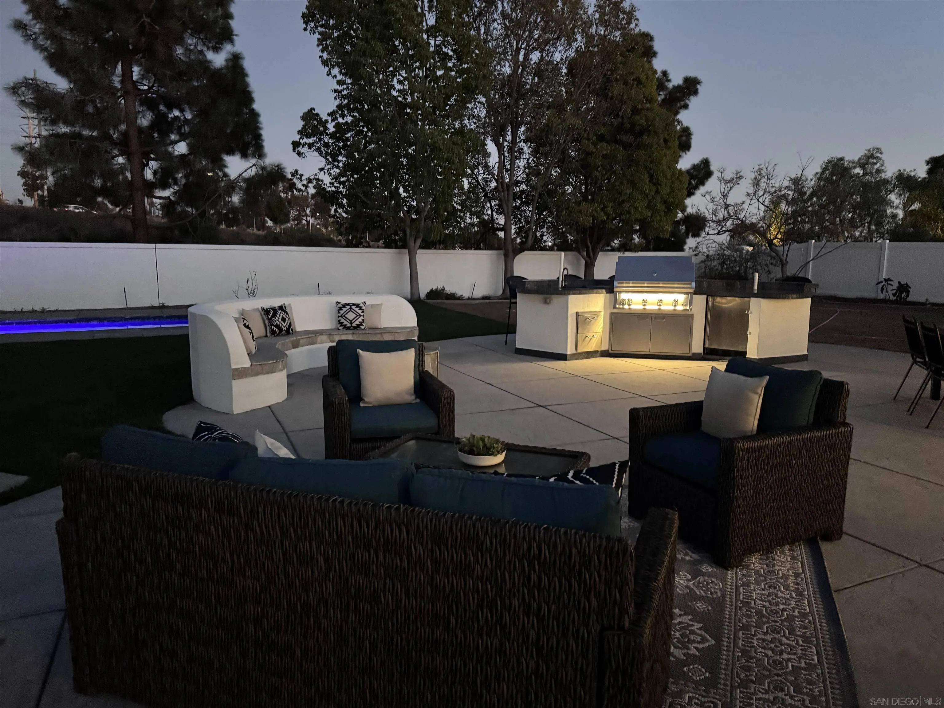 6814 Moorhen Place Carlsbad, CA 92011 - Photo 30 of 37 a view of a patio with couches table and chairs with potted plants and large trees