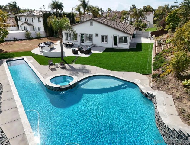 a view of a house with backyard porch and sitting area