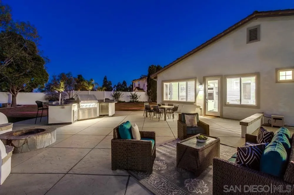 6814 Moorhen Place Carlsbad, CA 92011 - Photo 31 of 37 a living room with furniture a lamp and a potted plant