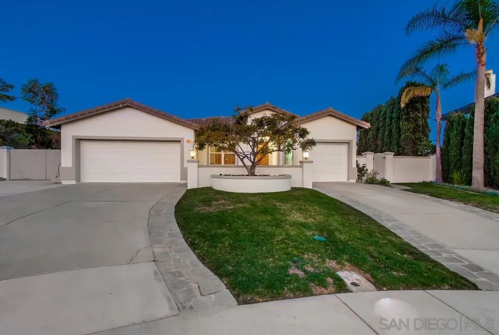 6814 Moorhen Place Carlsbad, CA 92011 - Photo 4 of 37 a front view of a house with a yard and garage