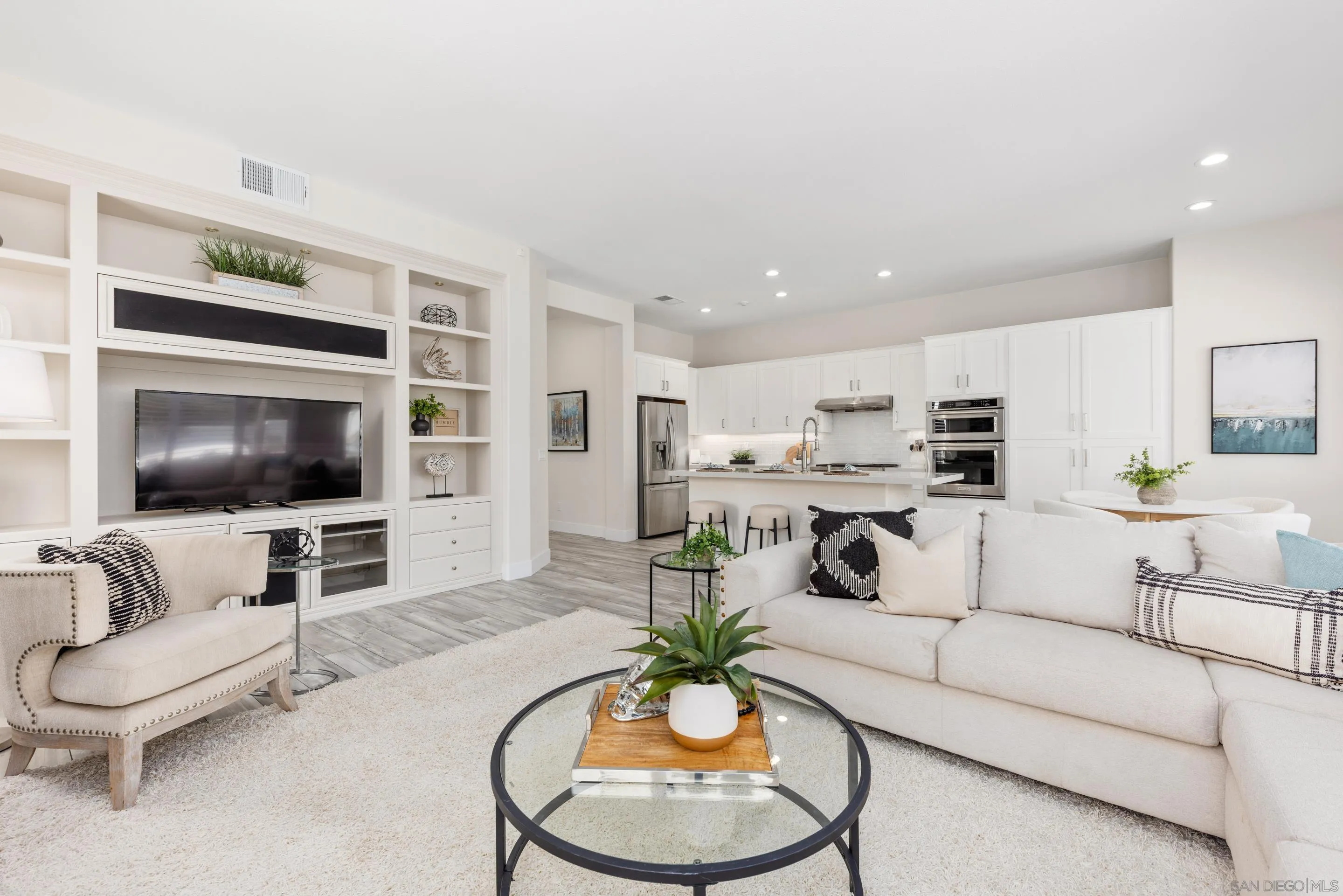 6814 Moorhen Place Carlsbad, CA 92011 - Photo 8 of 37 a living room with furniture and a flat screen tv