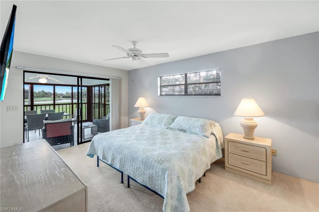 5585 Trailwinds Drive, Unit 326 Fort Myers, FL 33907 - Photo 15 of 37 a bedroom with bed and large window