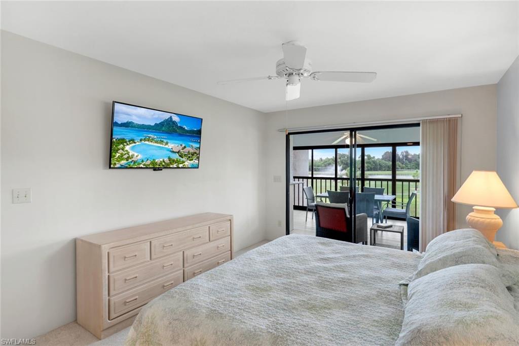 5585 Trailwinds Drive, Unit 326 Fort Myers, FL 33907 - Photo 16 of 37 a bedroom with a bed and a large window