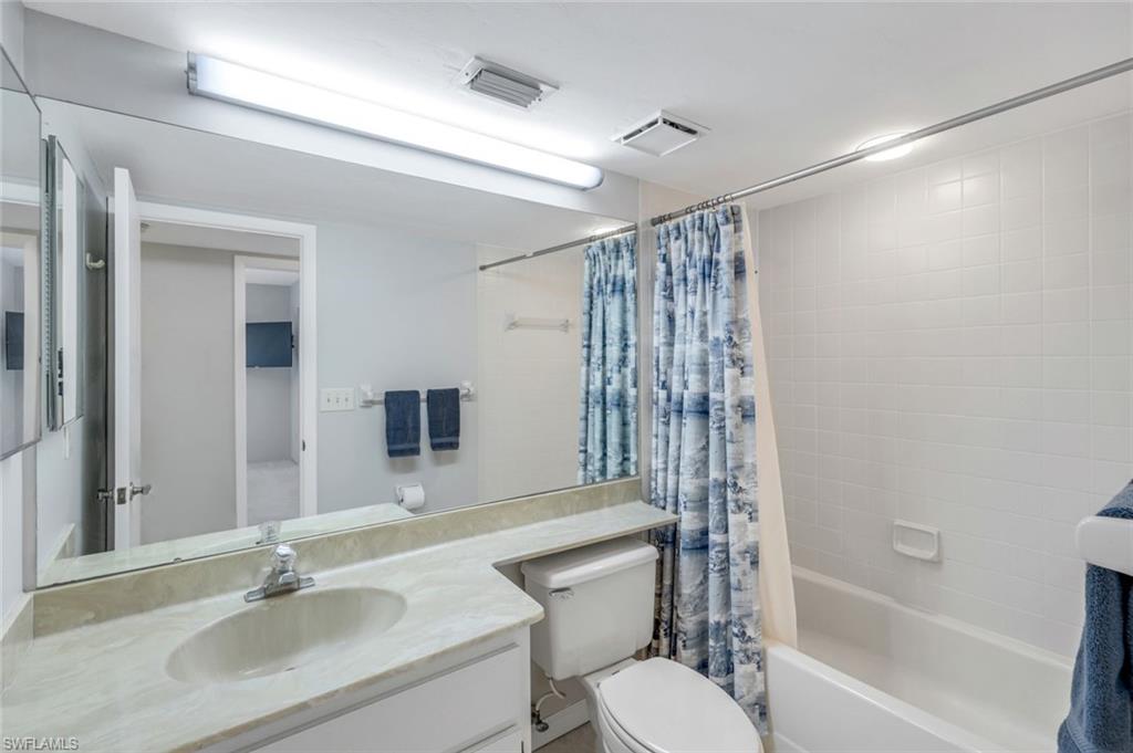 5585 Trailwinds Drive, Unit 326 Fort Myers, FL 33907 - Photo 20 of 37 a bathroom with a sink toilet a mirror and shower