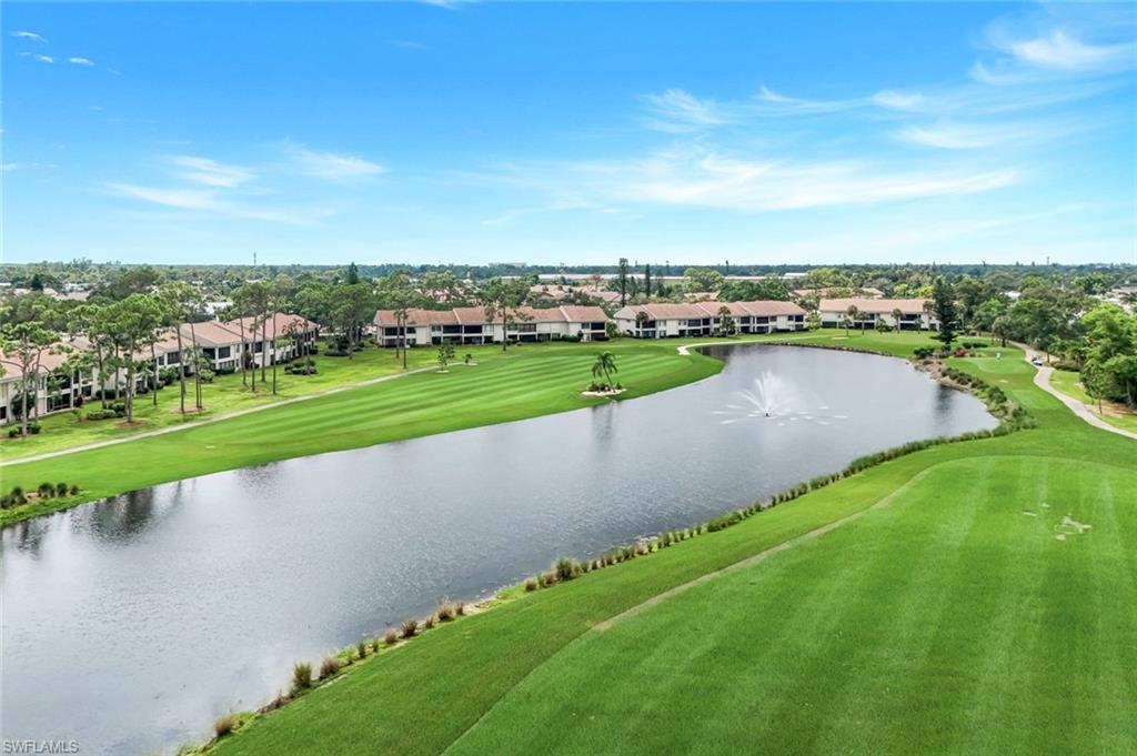 5585 Trailwinds Drive, Unit 326 Fort Myers, FL 33907 - Photo 2 of 37 a view of a lake with a big yard