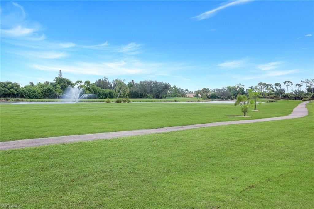 5585 Trailwinds Drive, Unit 326 Fort Myers, FL 33907 - Photo 24 of 37 a view of a golf course with a lake