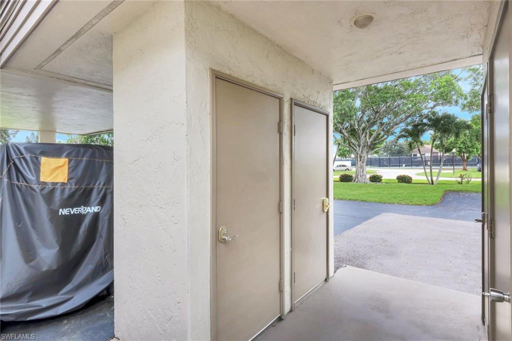 5585 Trailwinds Drive, Unit 326 Fort Myers, FL 33907 - Photo 27 of 37 a view of a porch with a garden