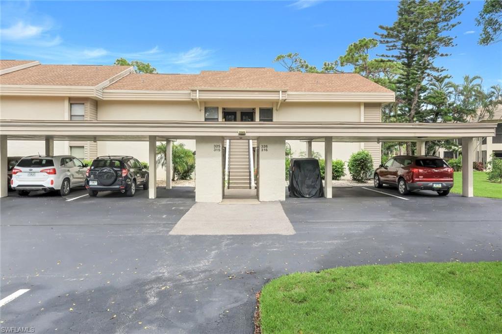 5585 Trailwinds Drive, Unit 326 Fort Myers, FL 33907 - Photo 3 of 37 a car parked in front of a house