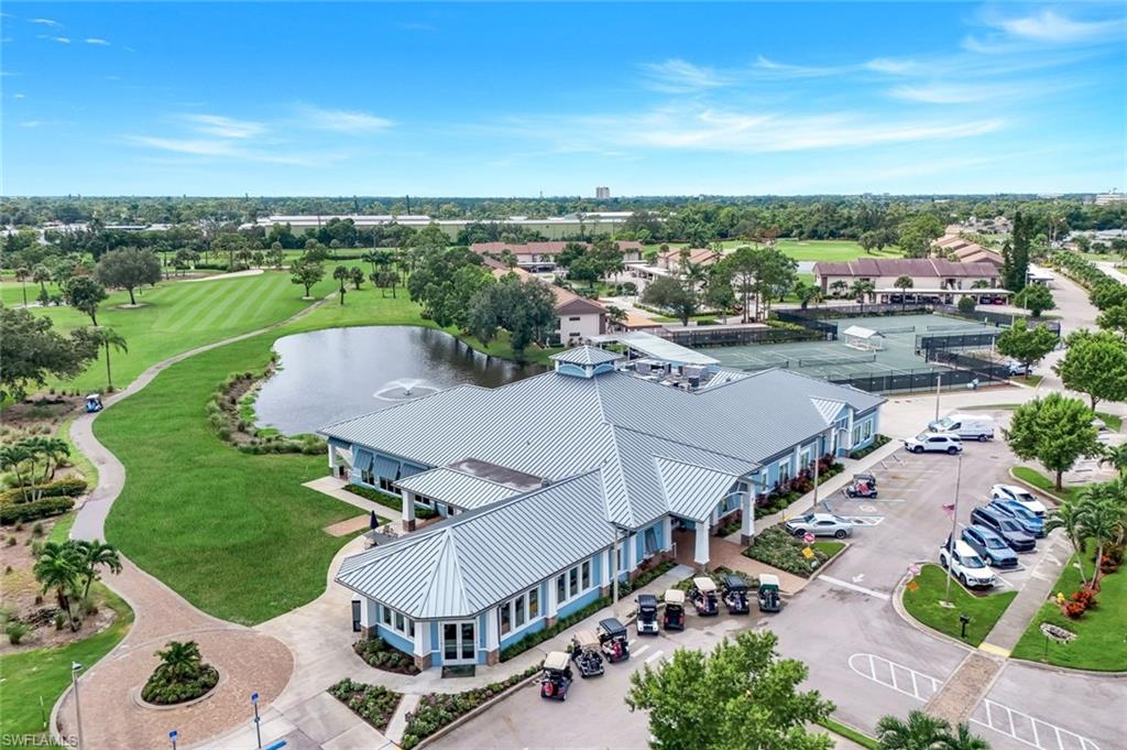 5585 Trailwinds Drive, Unit 326 Fort Myers, FL 33907 - Photo 34 of 37 an aerial view of a house with a garden and mountain view in back