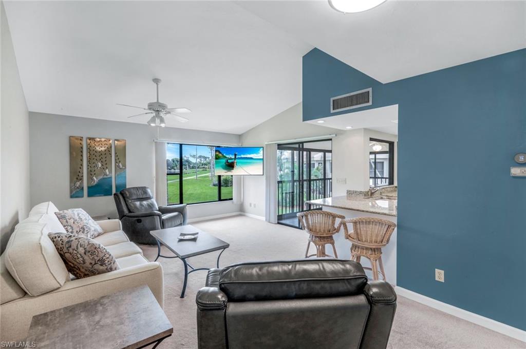 5585 Trailwinds Drive, Unit 326 Fort Myers, FL 33907 - Photo 6 of 37 a living room with furniture and a large window