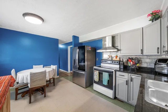 a kitchen with a refrigerator and cabinets