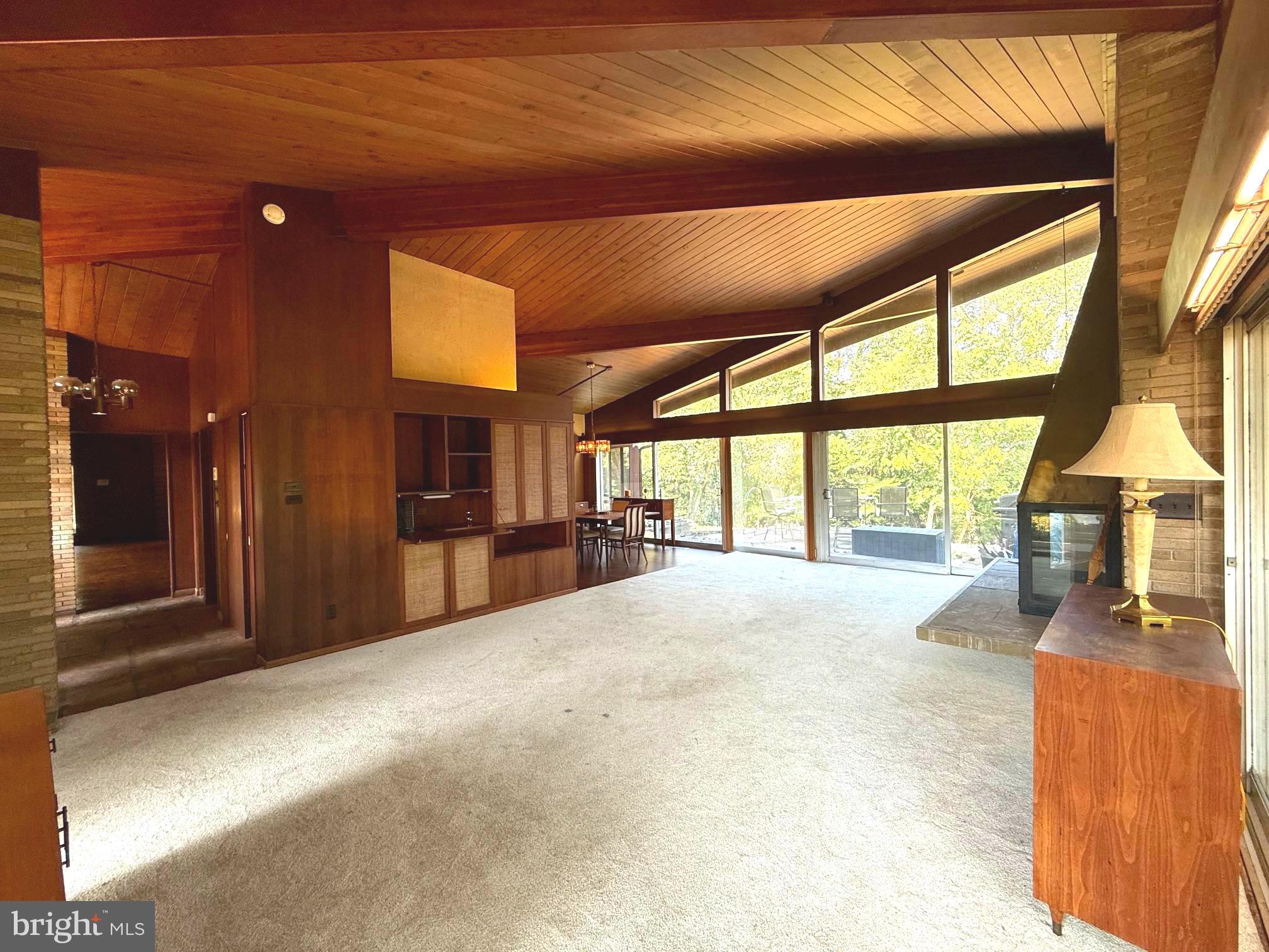108 South Spring Valley Road Wilmington, DE 19807 - Photo 13 of 84 a view of an empty room with a fireplace and windows