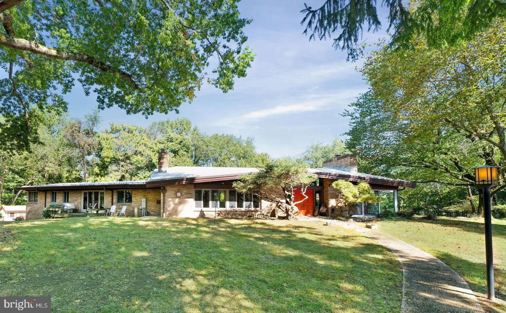 108 South Spring Valley Road Wilmington, DE 19807 - Photo 70 of 84 a view of a lake with a table and chairs under an umbrella