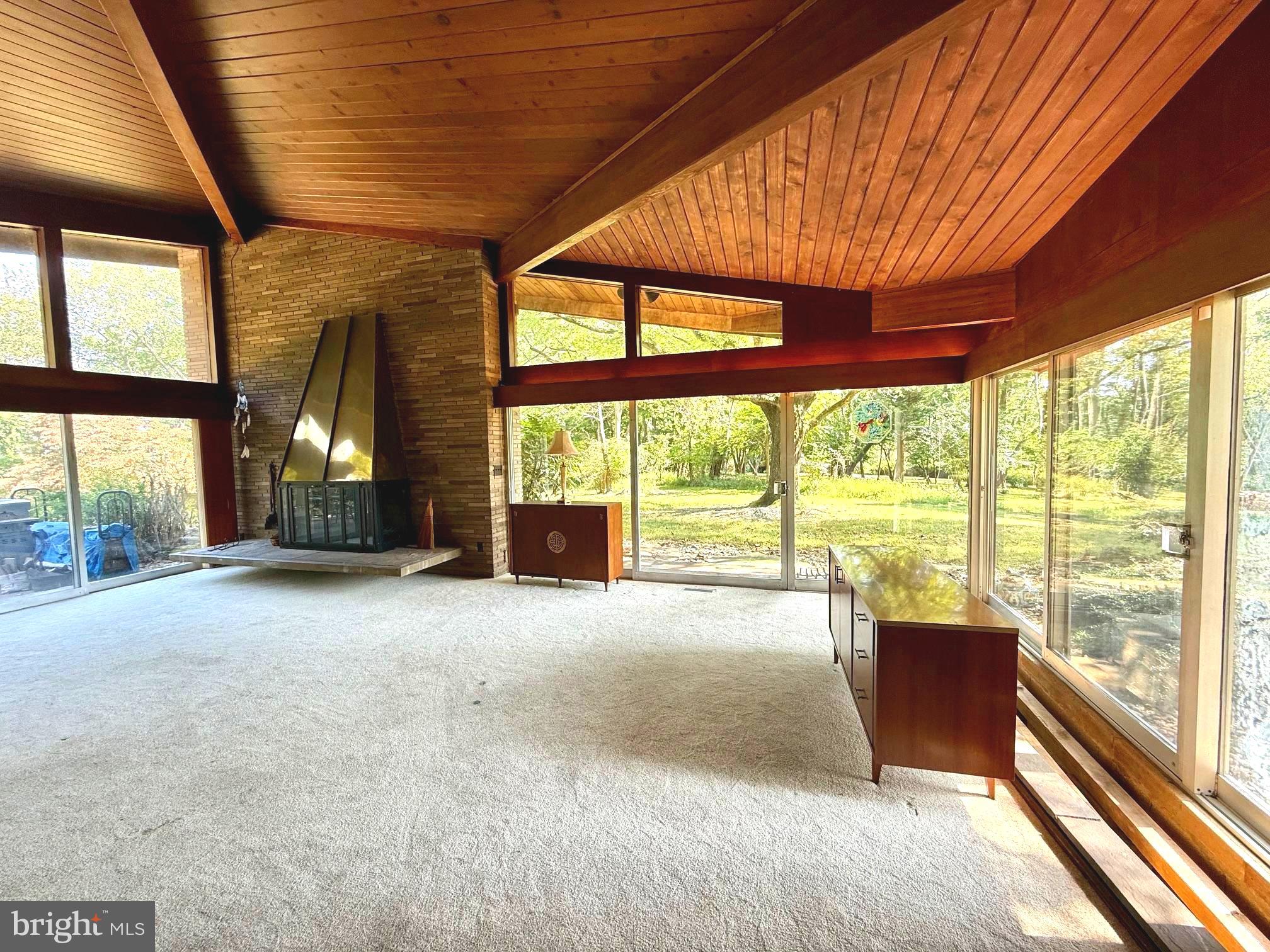 108 South Spring Valley Road Wilmington, DE 19807 - Photo 10 of 84 a view of an empty room with a fireplace and a large window