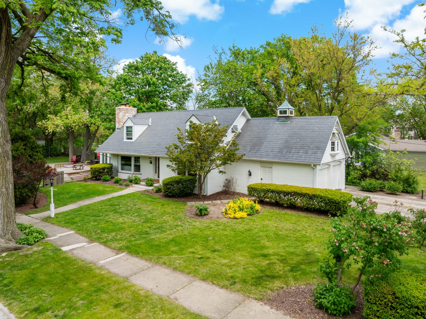 2160 Chestnut Road Homewood, IL 60430 - Photo 3 of 24 a front view of a house with a yard table and chairs