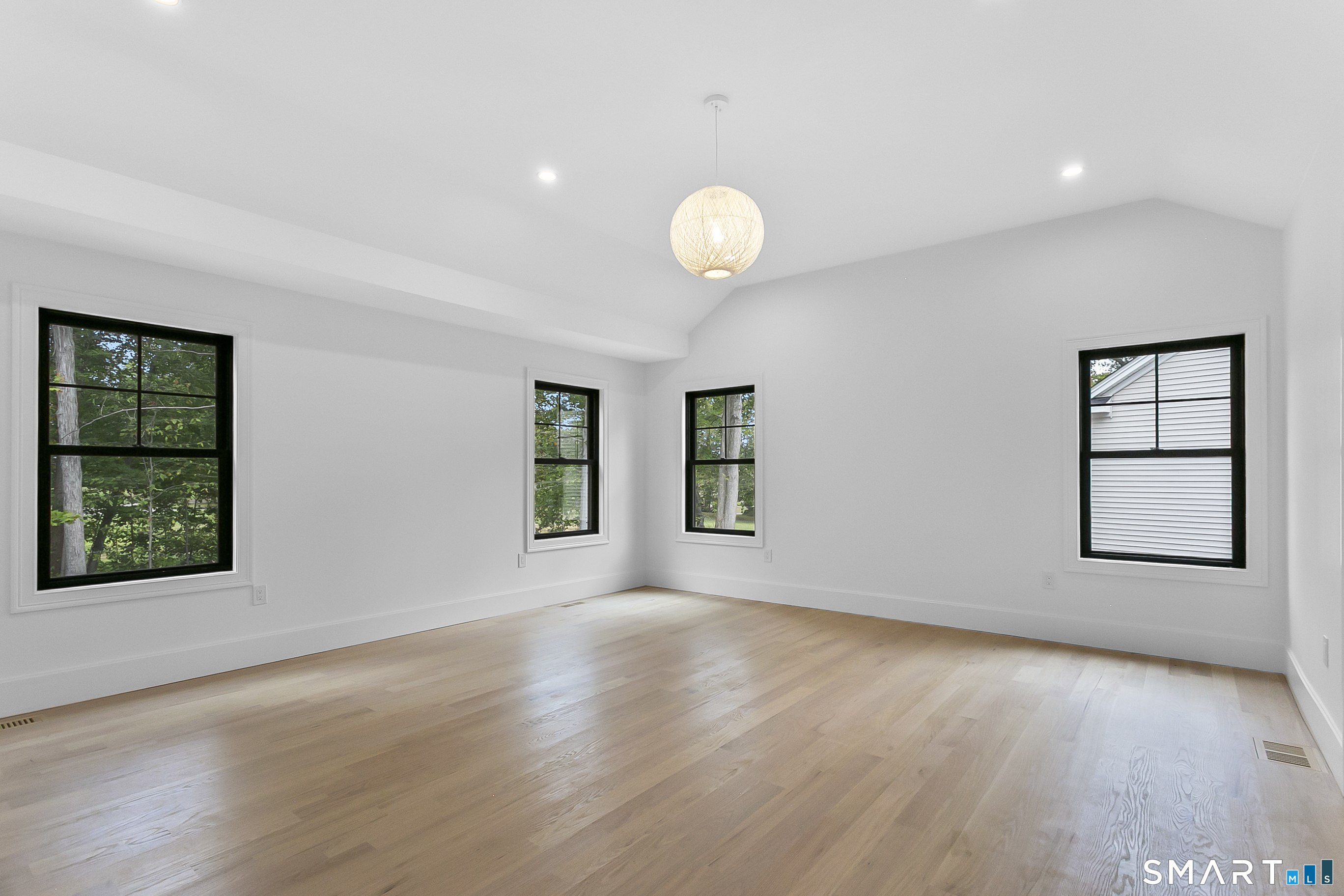 80 Oronoque Hills Road Stratford, CT 06614 - Photo 18 of 31 an empty room with wooden floor and windows