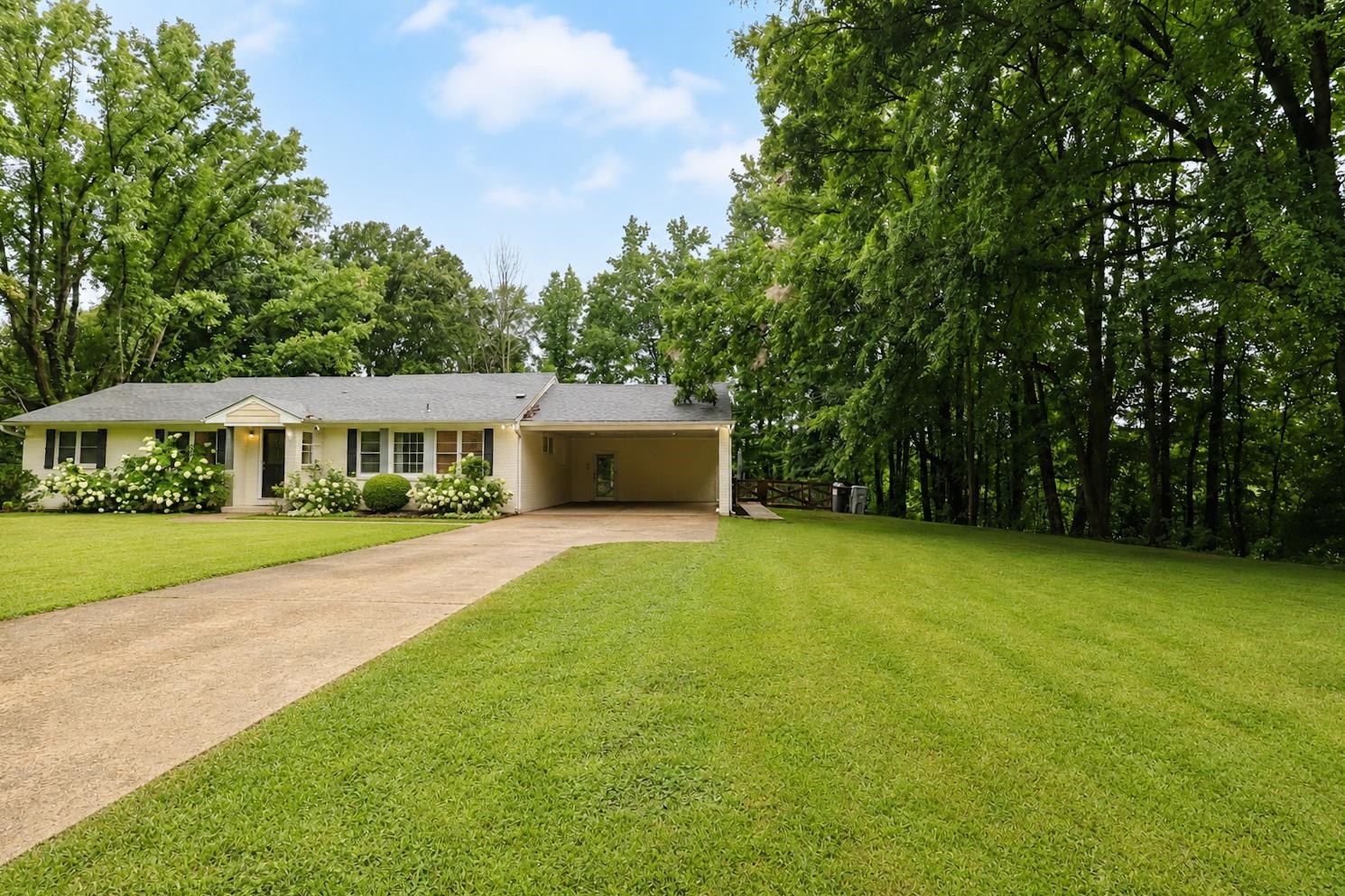 10093 Mt Carmel Road Brighton, TN 38011 - Photo 11 of 36 Ranch-style exterior with a light-colored facade, dark shutters, and a covered entryway