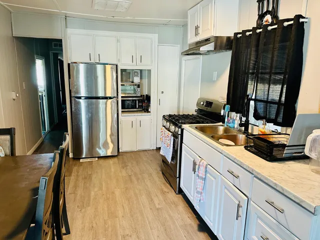 a kitchen with a sink appliances and cabinets