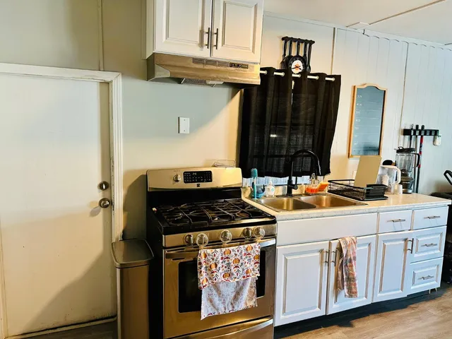 a kitchen with stainless steel appliances granite countertop a stove and a refrigerator