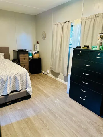 a bedroom with a bed and a dresser