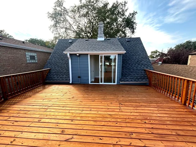 a view of a house with wooden deck
